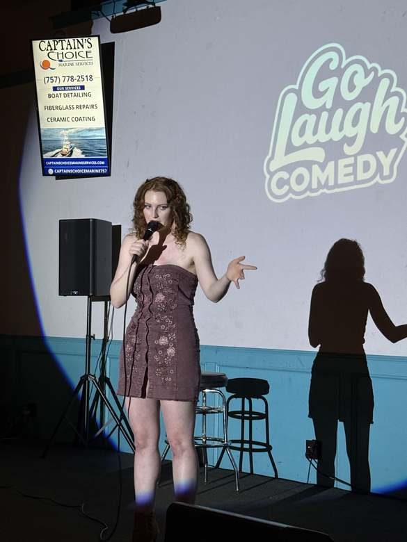 Comedian performing on stage at Go Laugh Comedy night at Ballyhoos