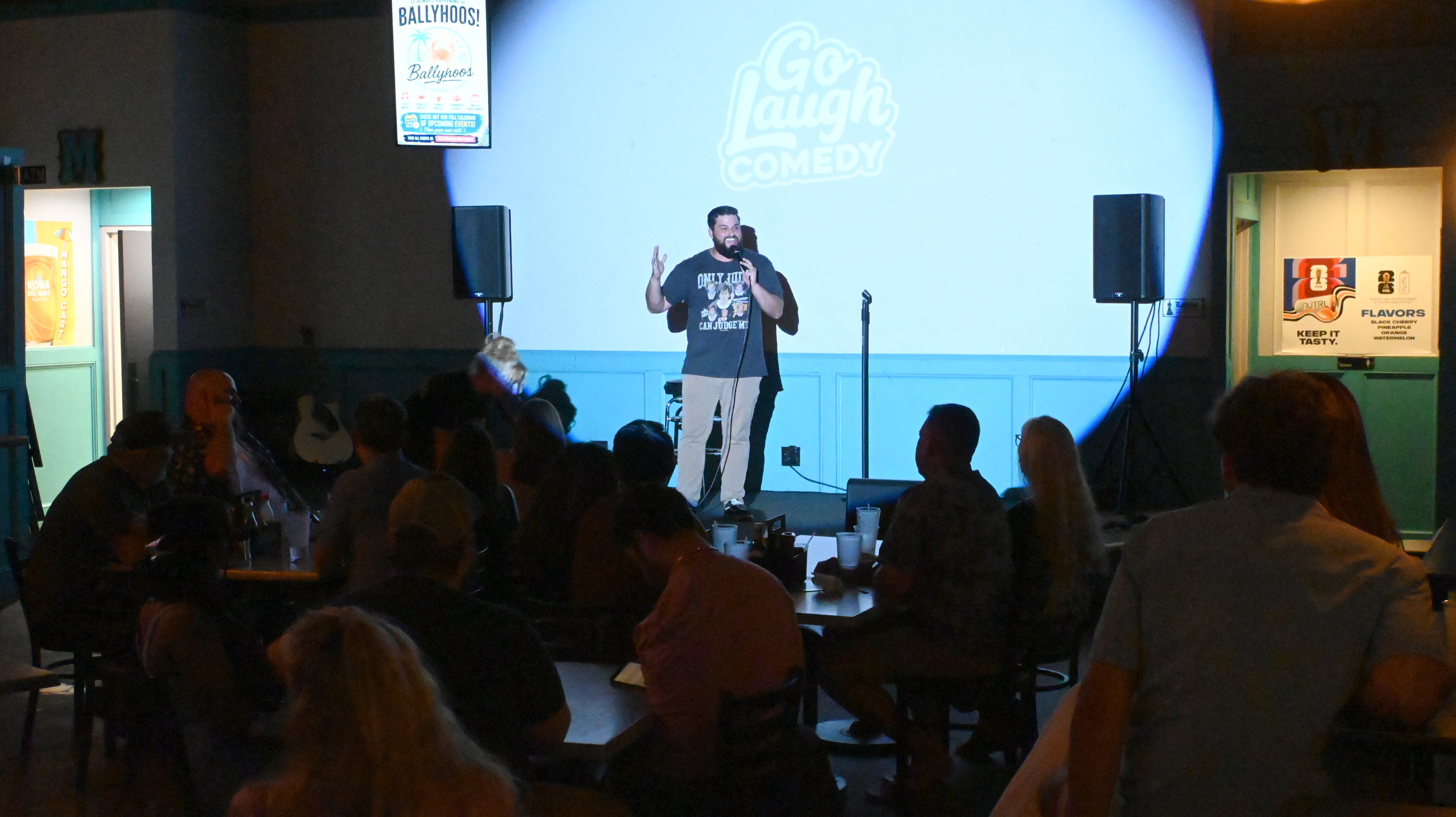 Comedian performing on stage at Ballyhoos
