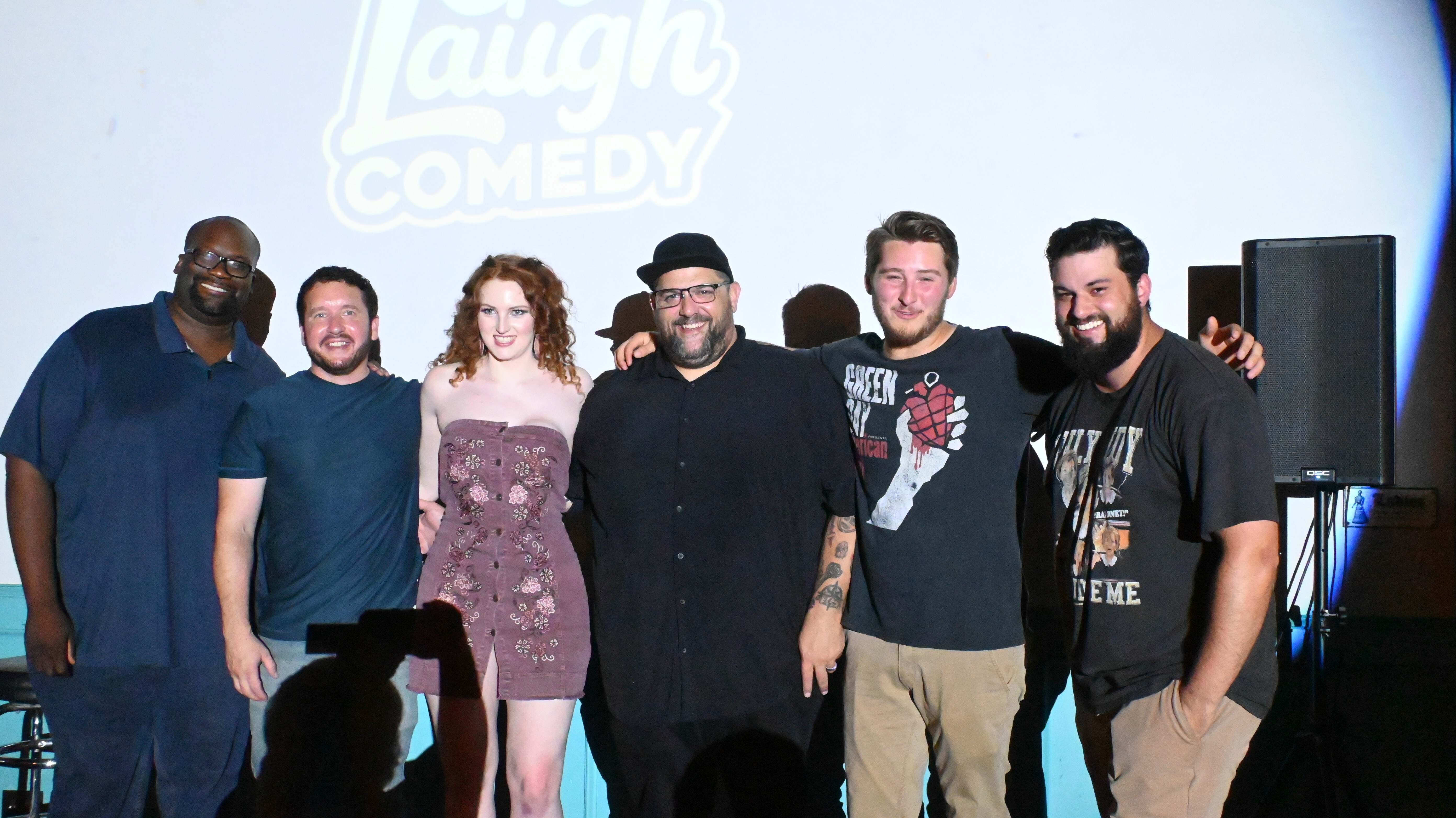 Comedians posing together on stage at Ballyhoos