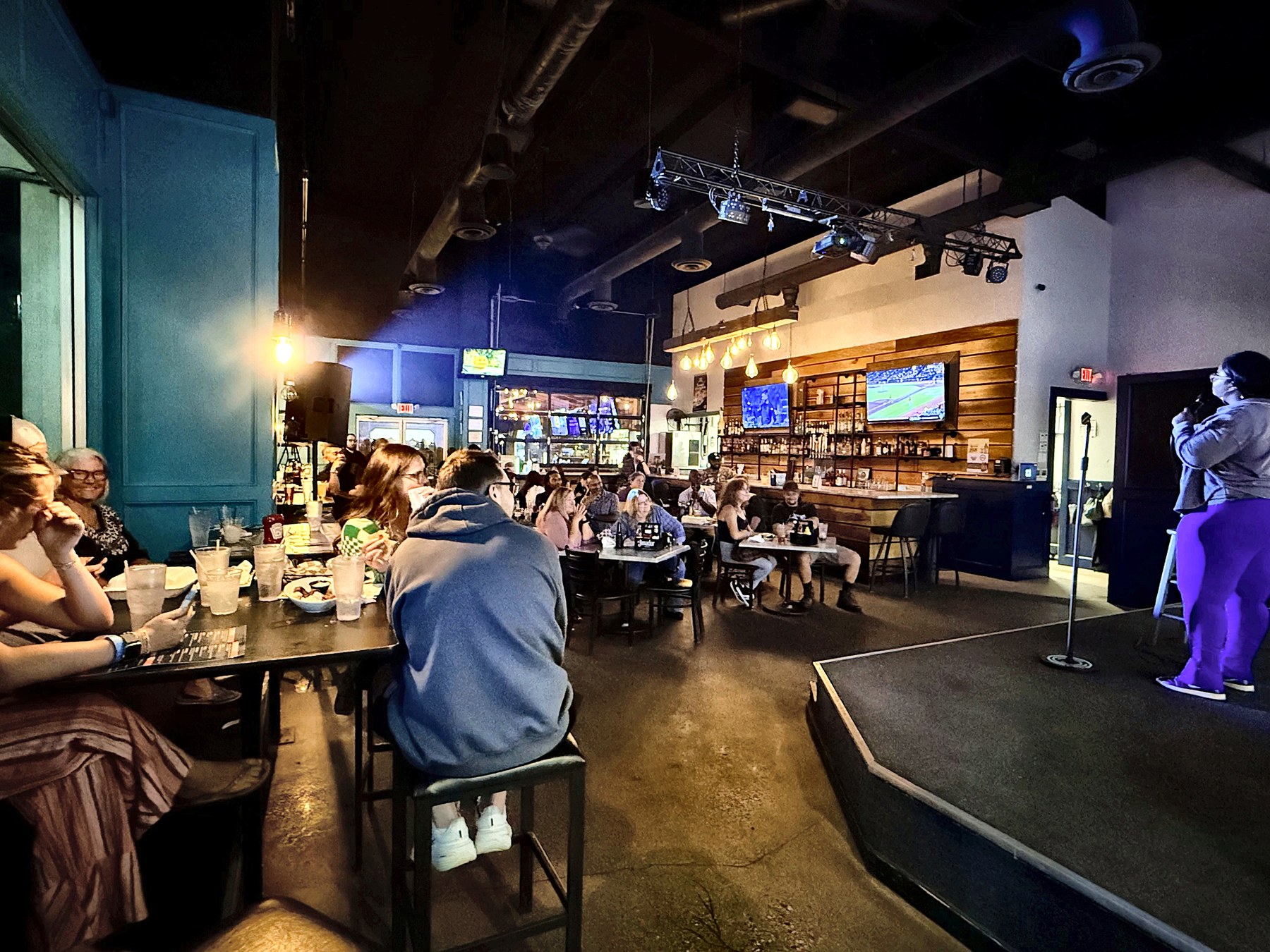 Crowd at the bar during a Go Laugh Comedy show at Ballyhoos