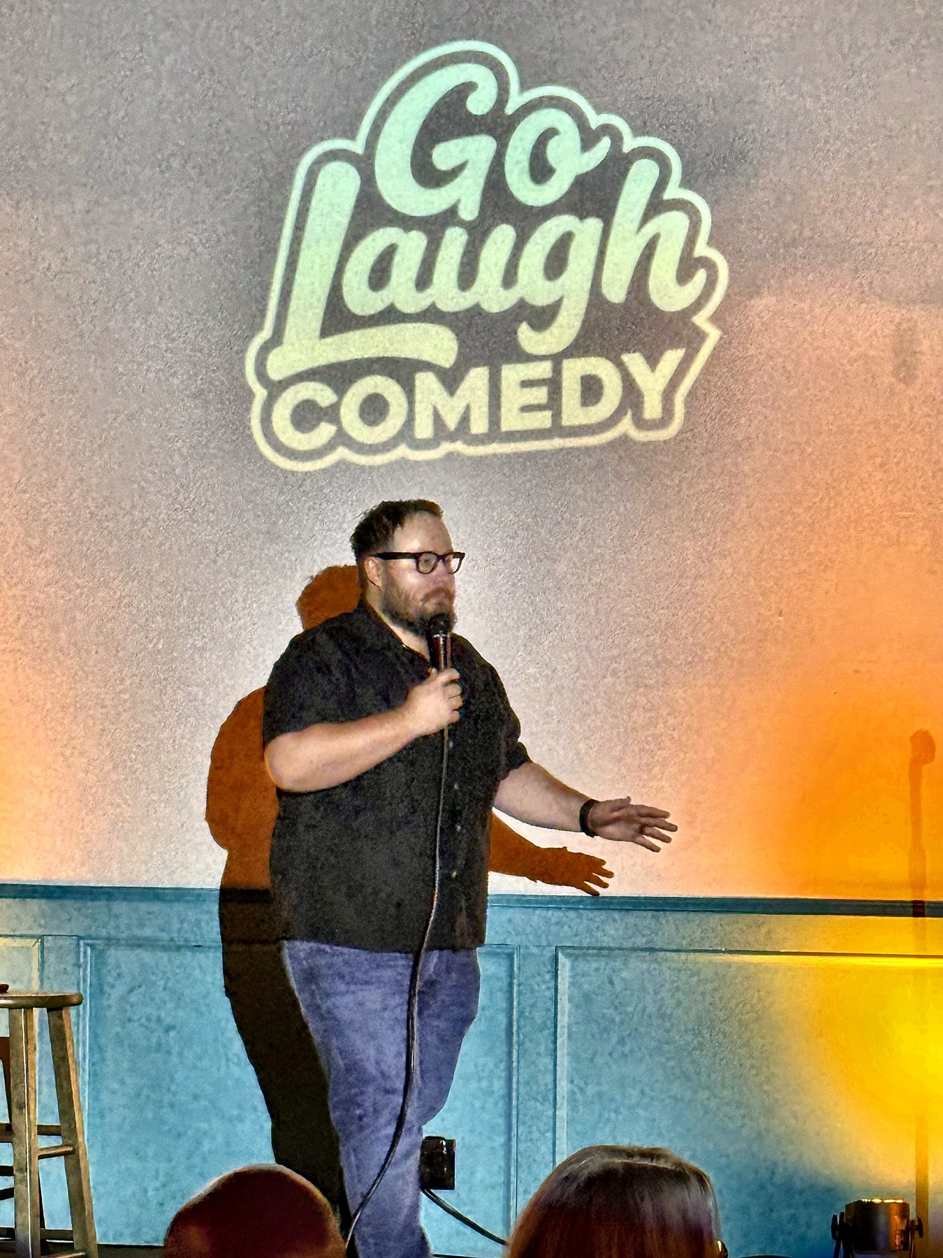Comedian performing on stage at Ballyhoos