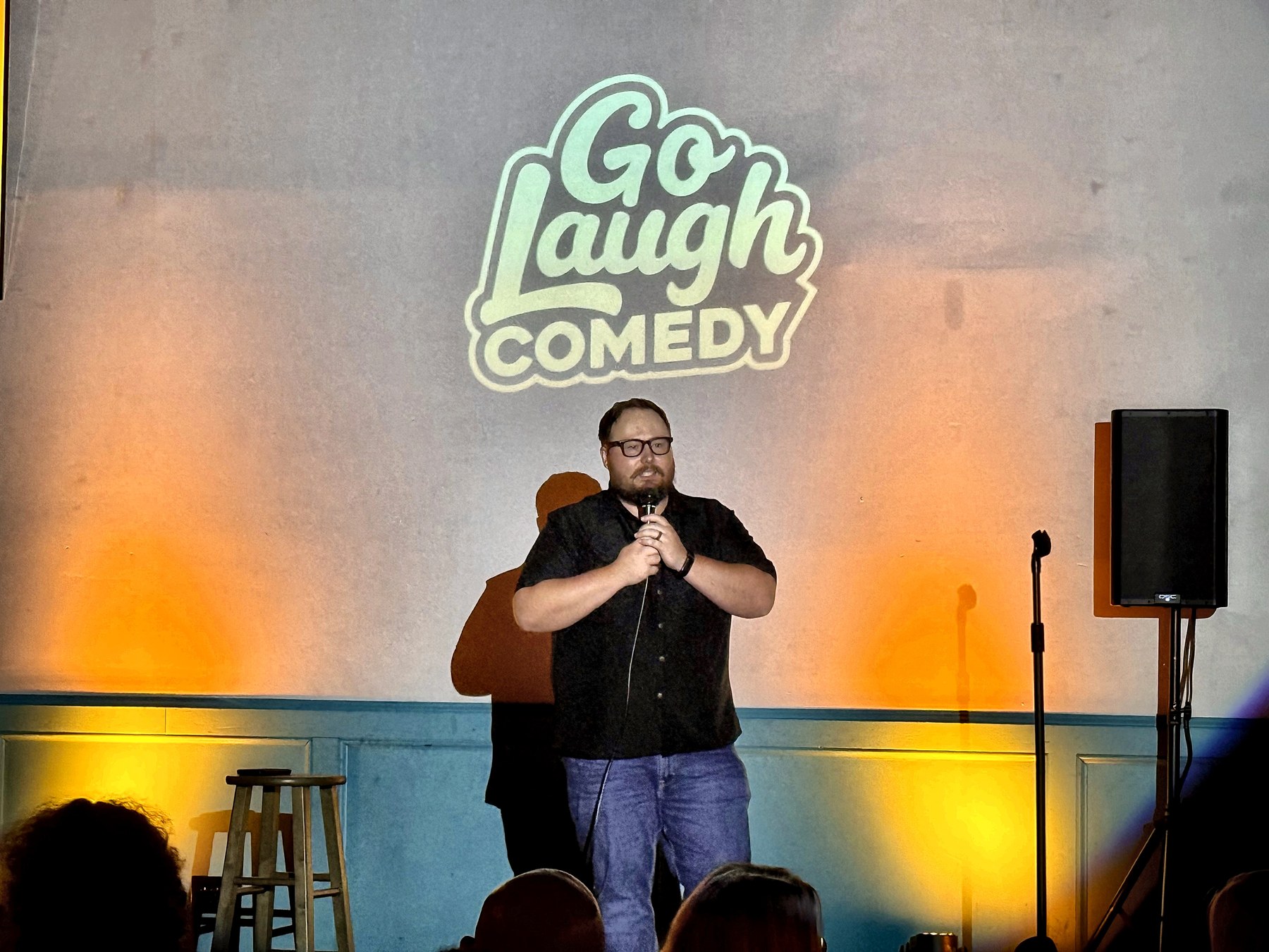 Comedian mid-bit on stage at Ballyhoos