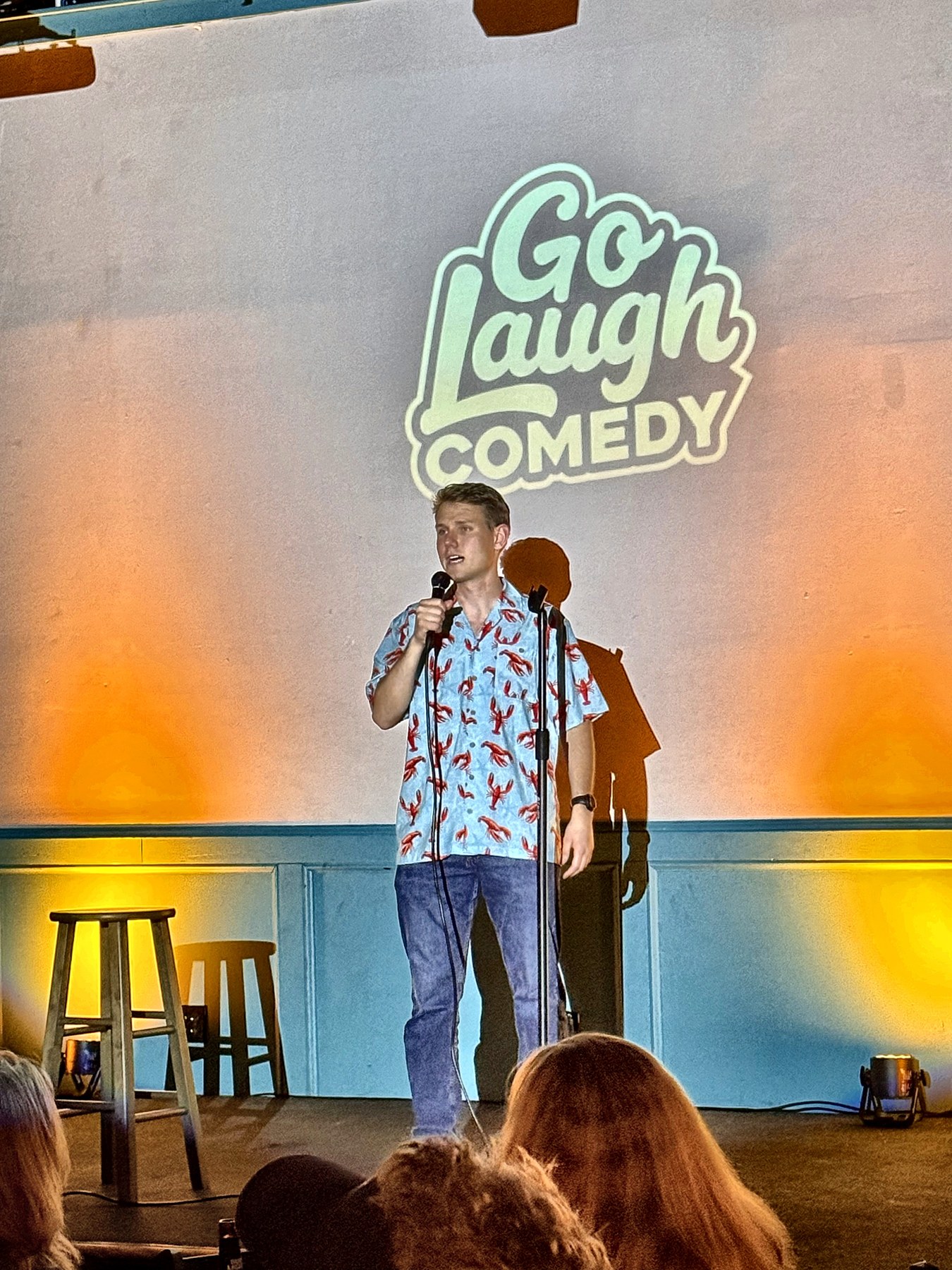 Comedian performing on stage at Go Laugh Comedy night at Ballyhoos