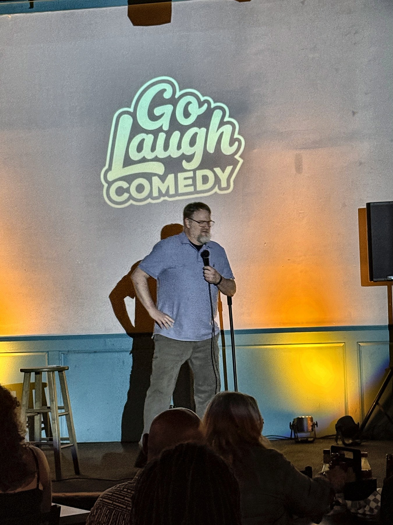 Comedian performing with the mic at Ballyhoos