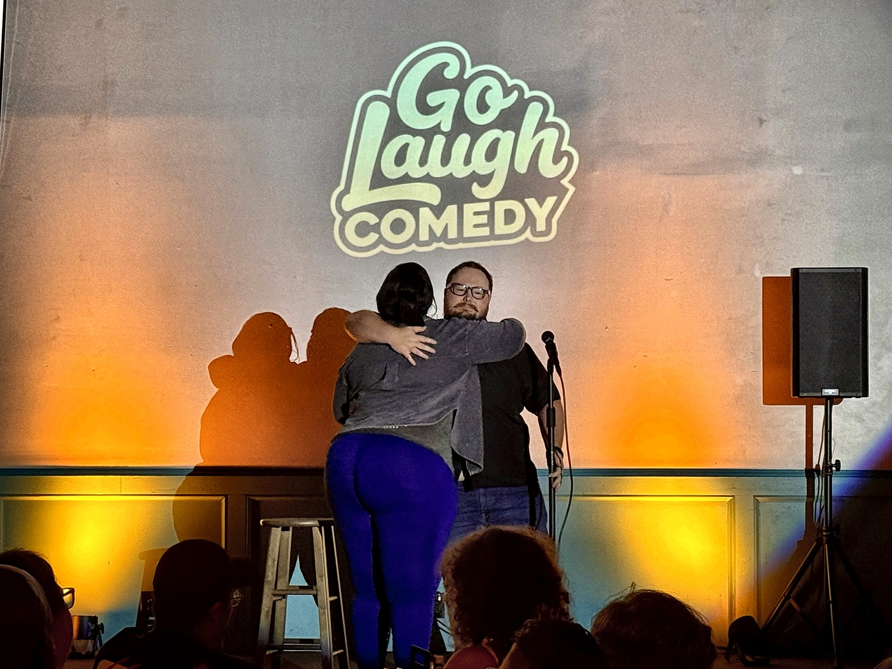 Comedians embracing on stage at Ballyhoos
