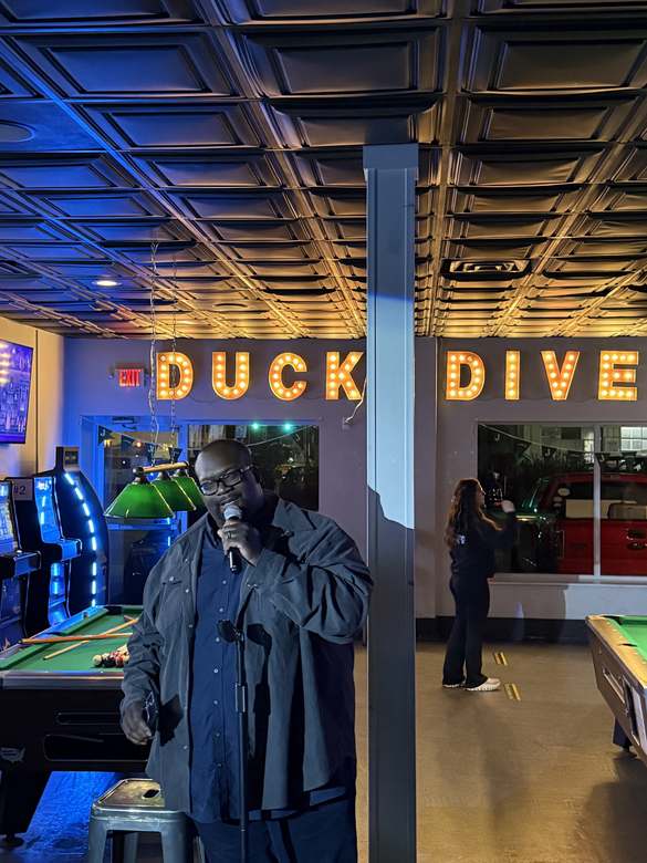 Comedian performing at Duck Dive Tavern open mic