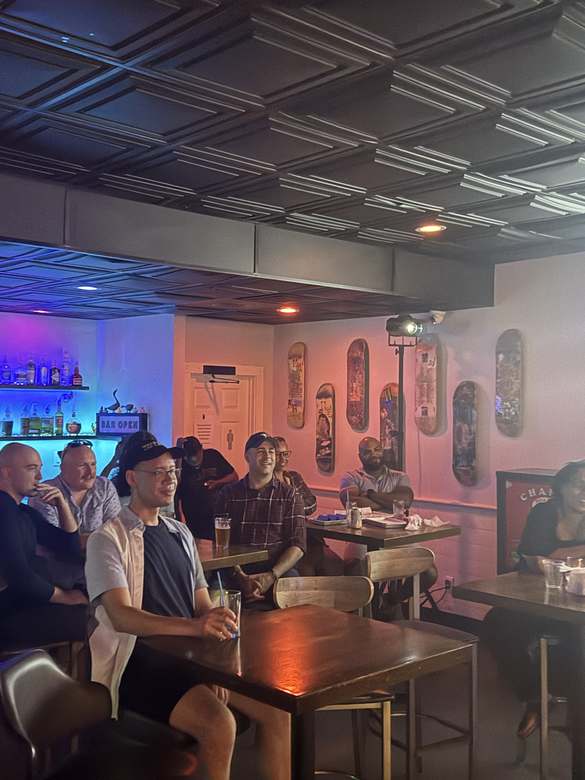 Crowd enjoying open mic comedy night at Duck Dive Tavern