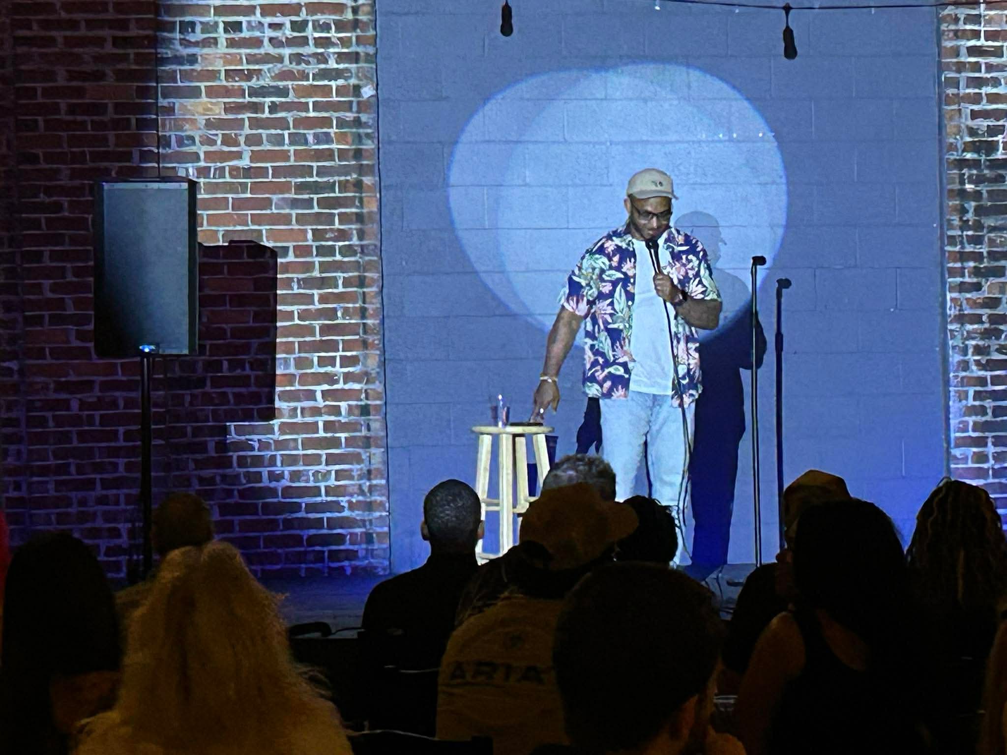 Comedian performing in the spotlight at Maker's Craft Brewery