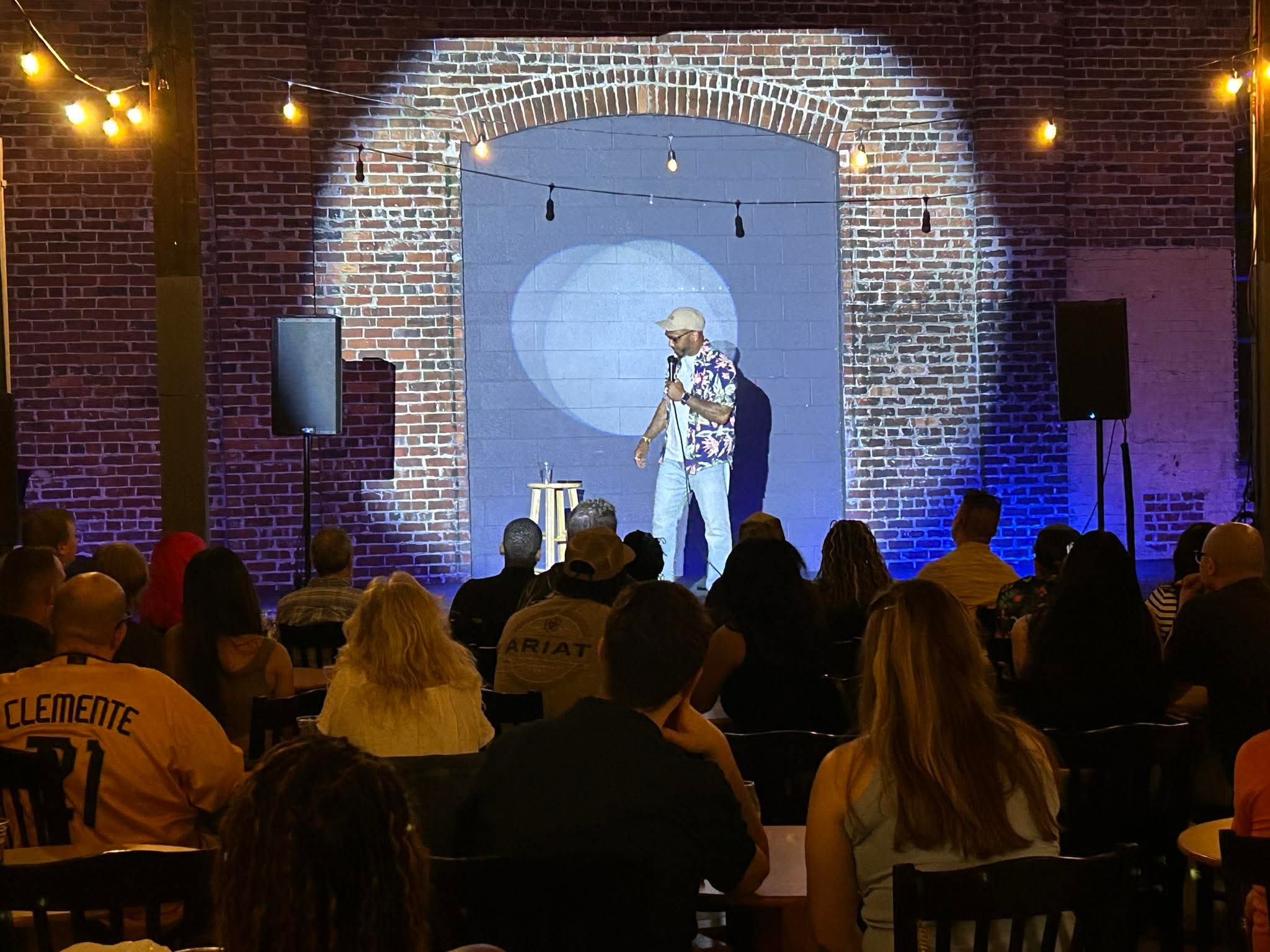 Comedian performing on stage at Maker's Craft Brewery