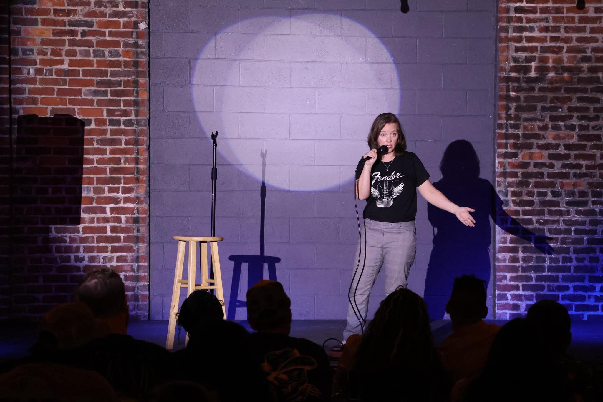 Comedian performing on stage at Maker's Craft Brewery