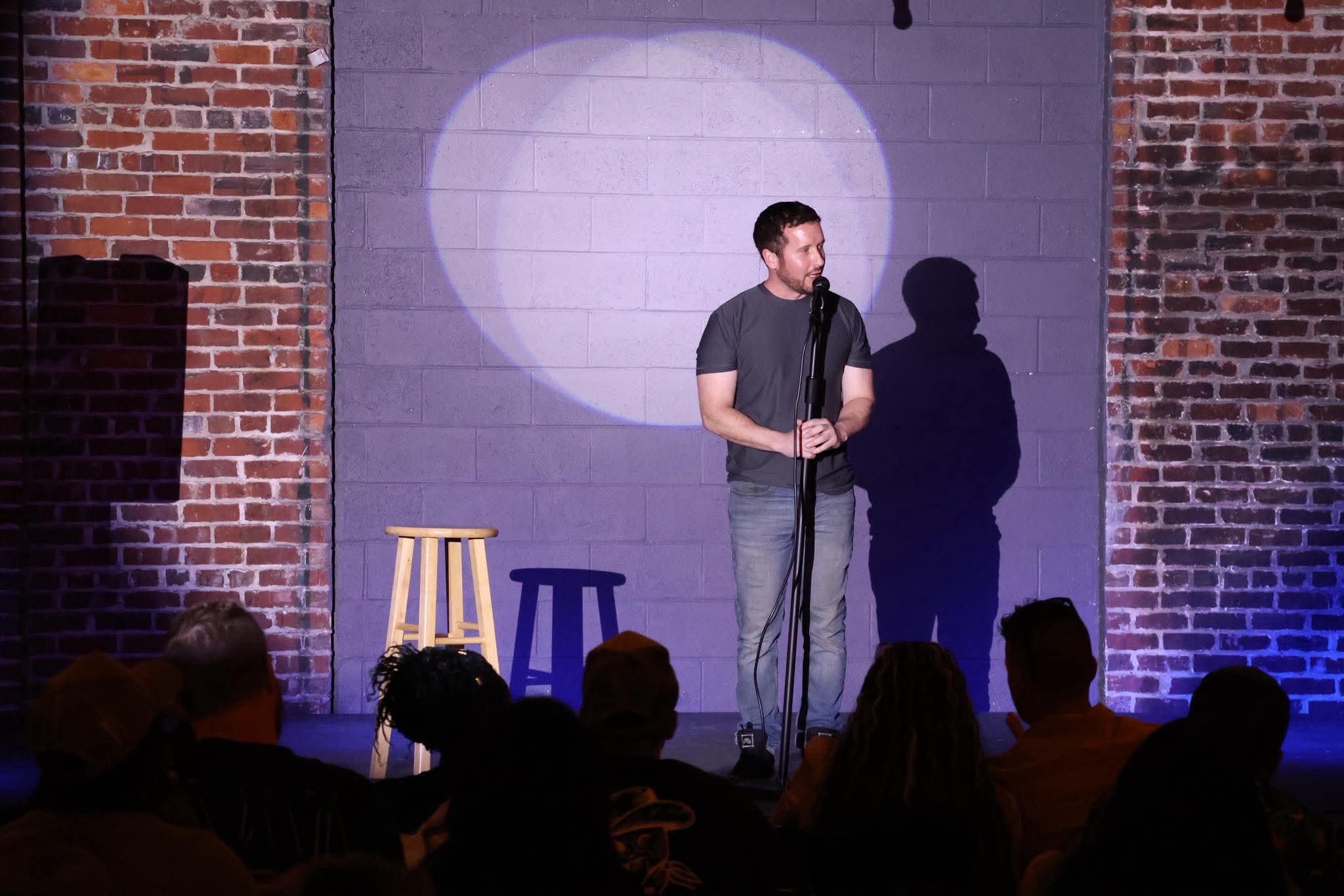 Comedian performing on stage at Maker's Craft Brewery