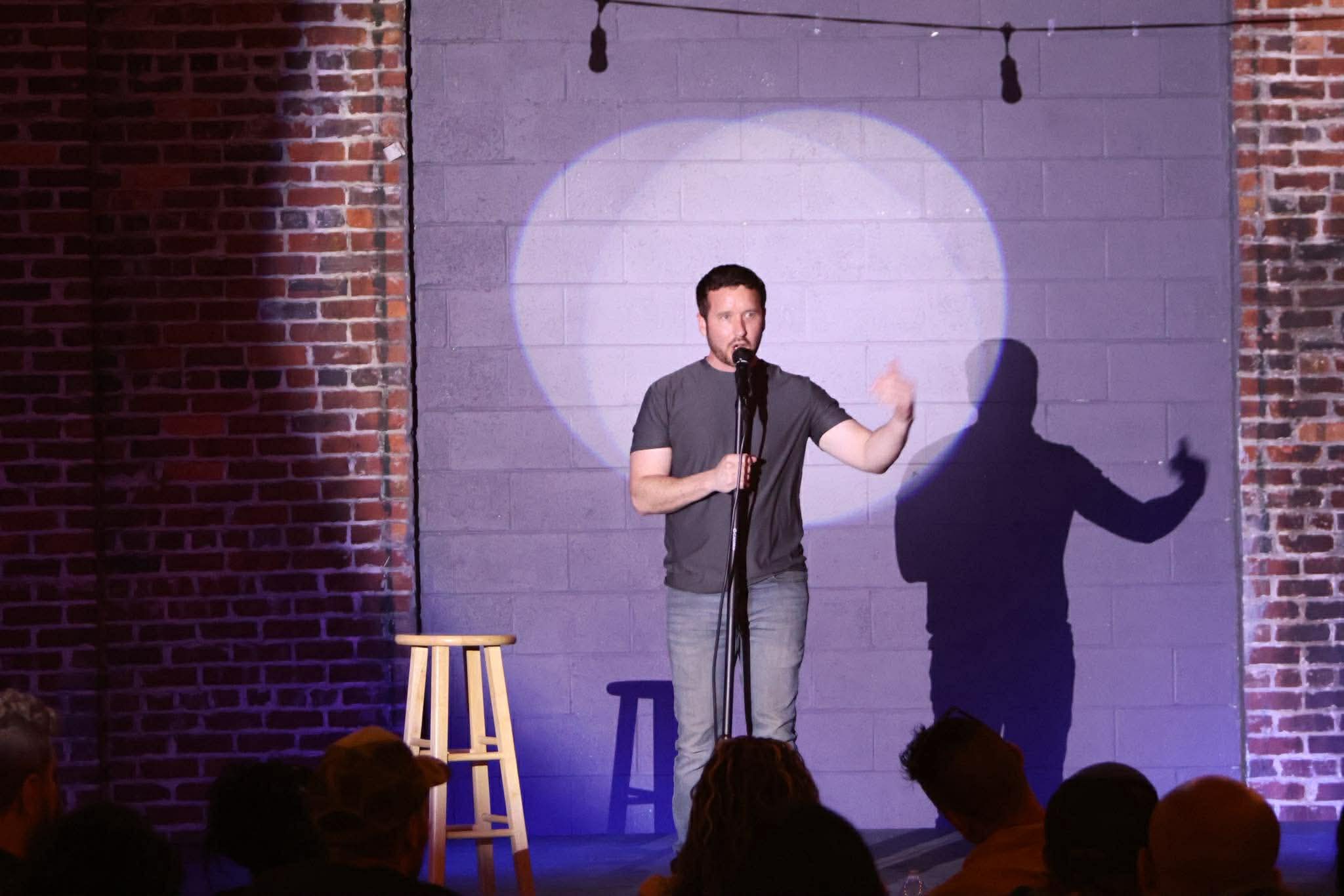 Comedian performing on stage at Maker's Craft Brewery