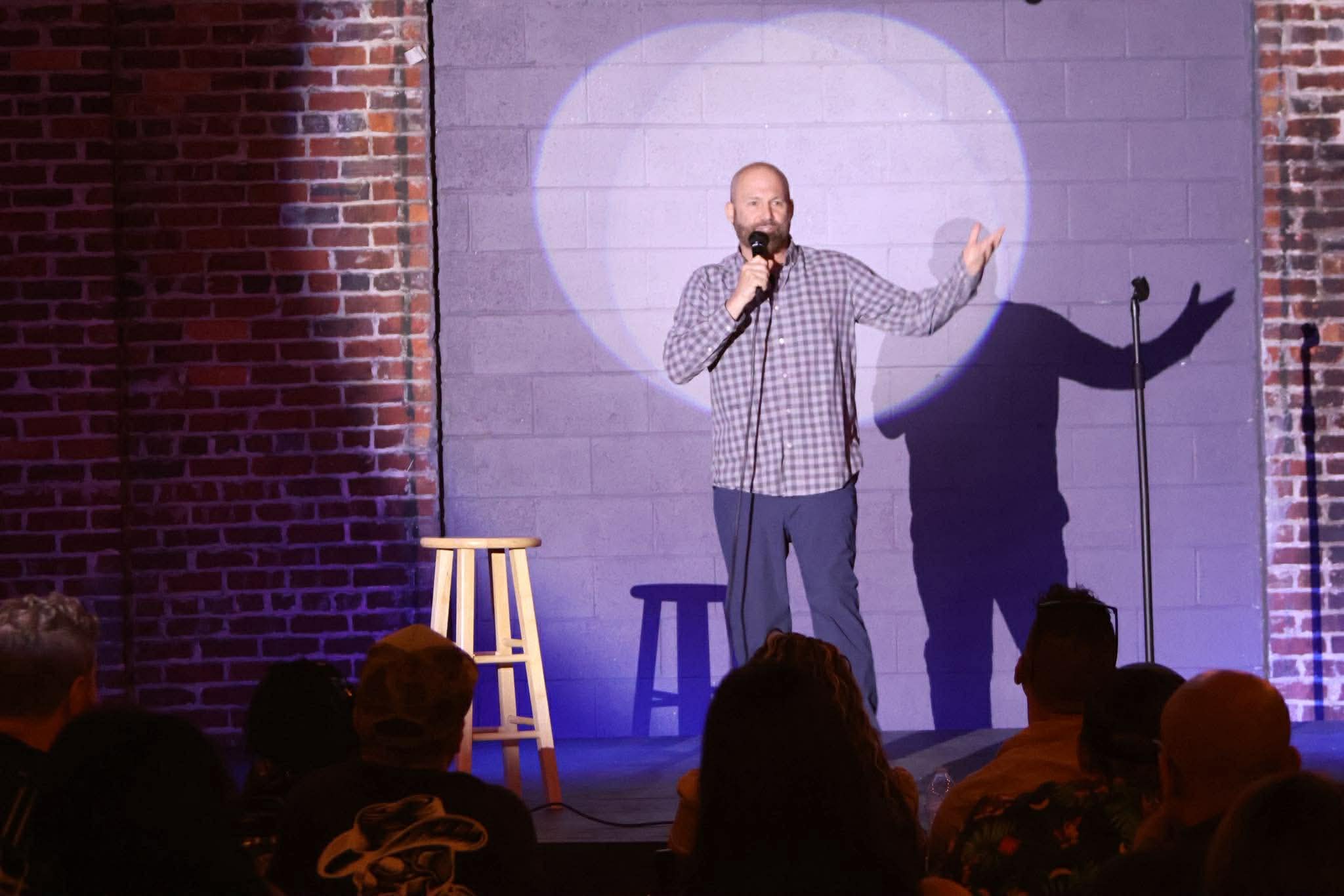 Comedian performing on stage at Maker's Craft Brewery